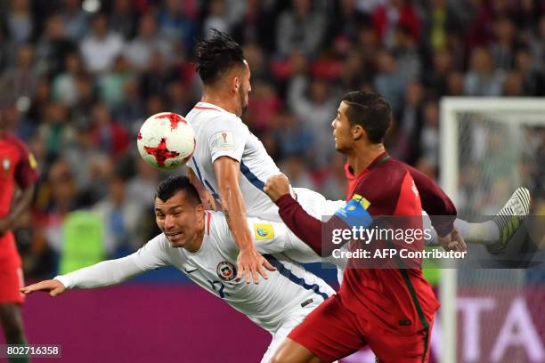 Portugal's forward Cristiano Ronaldo vies for the ball against Chile's defender Gary Medel during the 2017 Confederations Cup semi-final football...