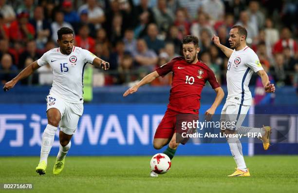 Jean Beausejour of Chile and Marcelo Diaz of Chile attempt to stop Bernardo Silva of Portugal from breaking through during the FIFA Confederations...