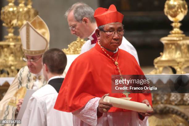 Newly appointed cardinal Louis-Marie Ling Mangkhanekhoun, receives the biretta cap from Pope during a consistory at St. Peter's Basilica on June 28,...