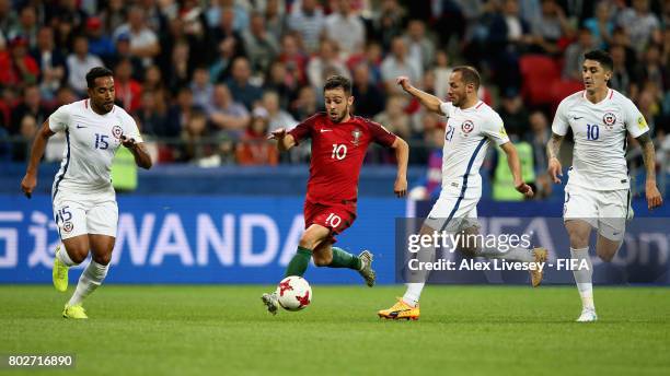 Jean Beausejour of Chile and Marcelo Diaz of Chile attempt to stop Bernardo Silva of Portugal from breaking through during the FIFA Confederations...