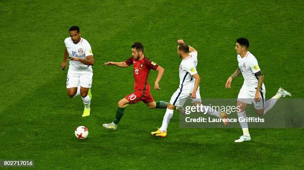 Jean Beausejour of Chile and Marcelo Diaz of Chile attempt to stop Bernardo Silva of Portugal from breaking through during the FIFA Confederations...