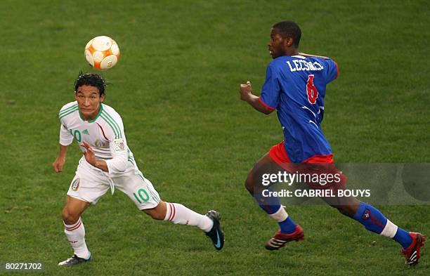 Mexico's striker Cesar Villaluz scores a goal before Haiti's defender Alain Vubert during their CONCACAF tournament Olympic qualifying match on March...