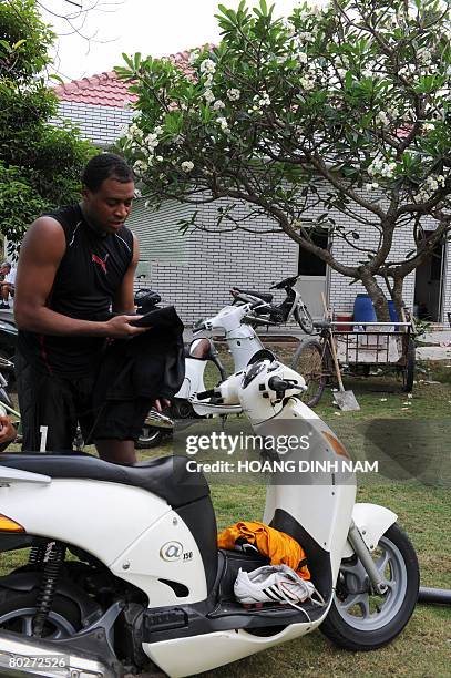 By Aude GENET Fabio Dos Santos prepares to leave on a scooter after a training session with his Vietnamese soccer club Dong Tam-Long An in Ben Luc,...