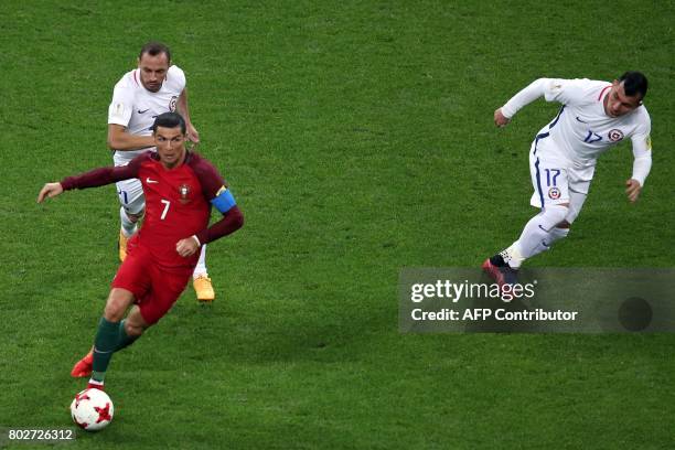 Portugal's forward Cristiano Ronaldo vies with Chile's defender Gary Medel (R0 during the 2017 Confederations Cup semi-final football match between...