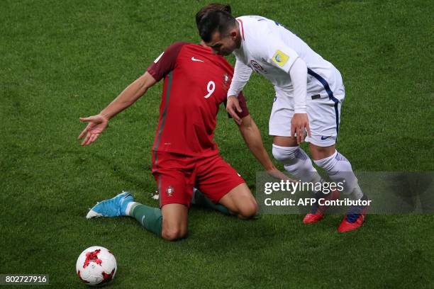 Portugal's forward Andre Silva vies with Chile's defender Gary Medel during the 2017 Confederations Cup semi-final football match between Portugal...