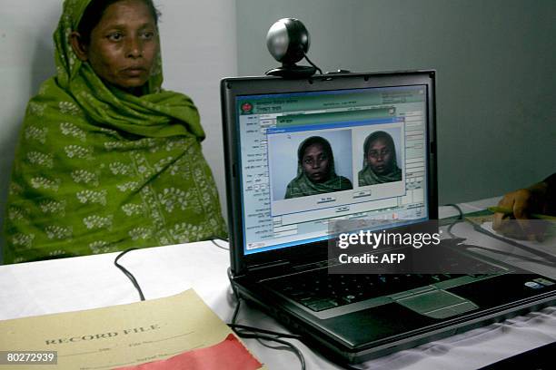 Bangladeshi villager has her photograph and signature taken and saved to an extensive database in Rajashi Division some 200kms north-west of Dhaka on...