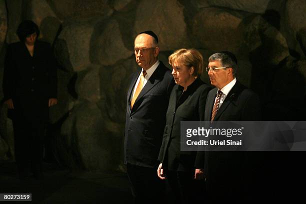 German Chancellor Angela Merkel stands with Israeli Prime Minister Ehud Olmert and the chairman of Yad Vashem Avner Shalev in the Hall of...