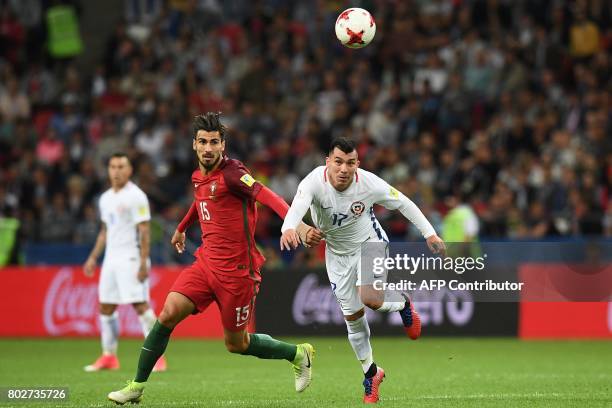 Portugal's midfielder Andre Gomes vies for the ball against Chile's defender Gary Medel during the 2017 Confederations Cup semi-final football match...