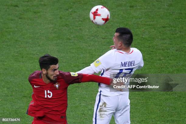 Portugal's midfielder Andre Gomes vies with Chile's defender Gary Medel during the 2017 Confederations Cup semi-final football match between Portugal...
