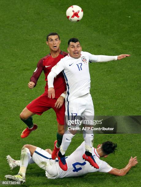 Portugal's forward Cristiano Ronaldo vies with Chile's defender Gary Medel and Chile's defender Mauricio Isla during the 2017 Confederations Cup...