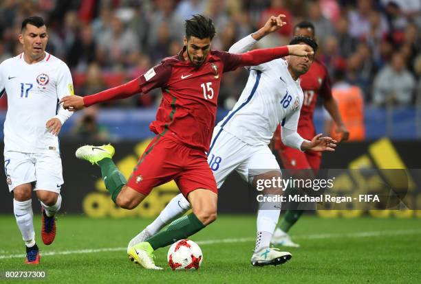 Andre Gomes of Portugal attempts to shoot while under pressure from Gonzalo Jara of Chile during the FIFA Confederations Cup Russia 2017 Semi-Final...