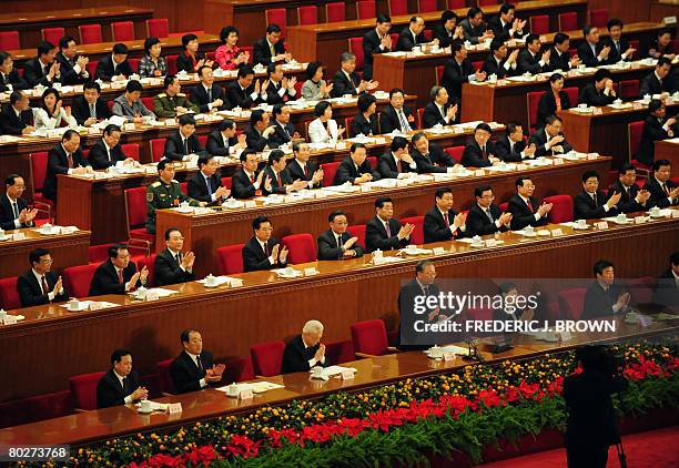 China's ruling Communists applaud themselves inside the Great Hall of the People during a session of the National People's Congress, its annual...