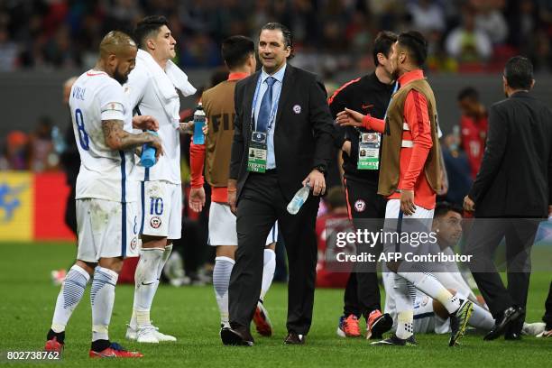 Chile's Spanish coach Juan Antonio Pizzi walks towards his player as the match goes into extra time during the 2017 Confederations Cup semi-final...