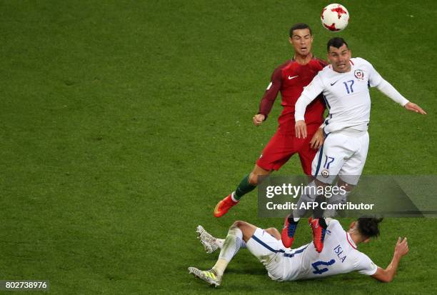 Portugal's forward Cristiano Ronaldo vies with Chile's defender Gary Medel and Chile's defender Mauricio Isla during the 2017 Confederations Cup...