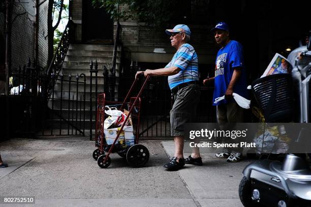 Food is handed out at a street food pantry following the release of a report that says poverty has increased on June 28, 2017 in the Bronx borough of...