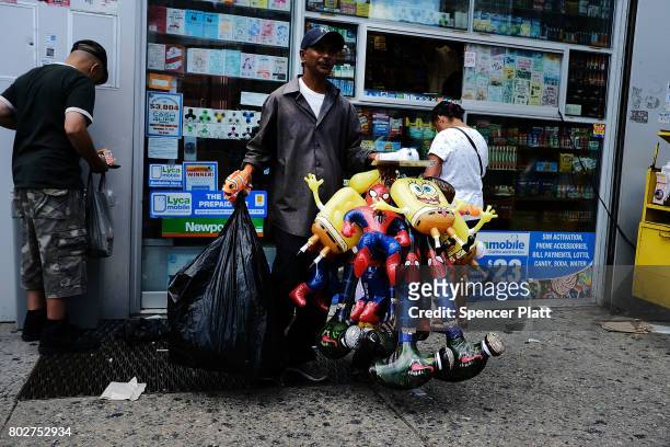Man sells items on a street following the release of a report that says poverty has increased on June 28, 2017 in the Bronx borough of New York City....