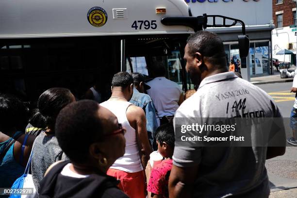 People wait for a bus following the release of a report that says poverty has increased on June 28, 2017 in the Bronx borough of New York City....