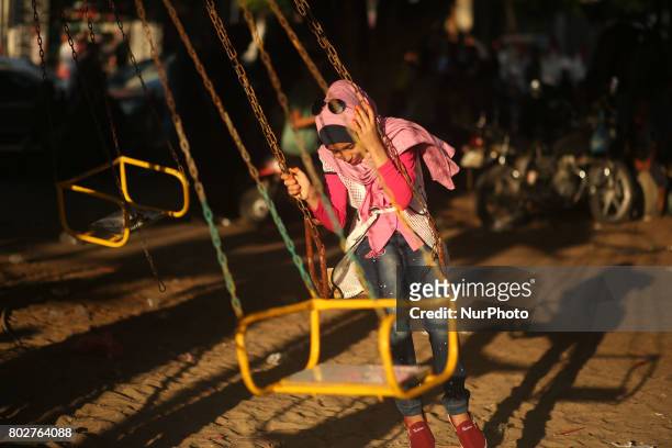 Palestinian children play in a park on the fourth day of Eid al-Fitr, which marks the end of the holy month of Ramadan. Eid al - Fitr holiday...