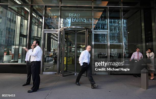 People stand outside the offices of global investment bank, securities trading and brokerage firm Bear, Stearns & Co. On Madison Ave on March 17,...