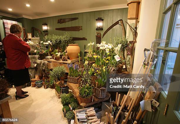 Customer browses products displayed in the Highgrove shop opened by Prince Charles, Prince of Wales and Camilla, Duchess of Cornwall on Tetbury High...