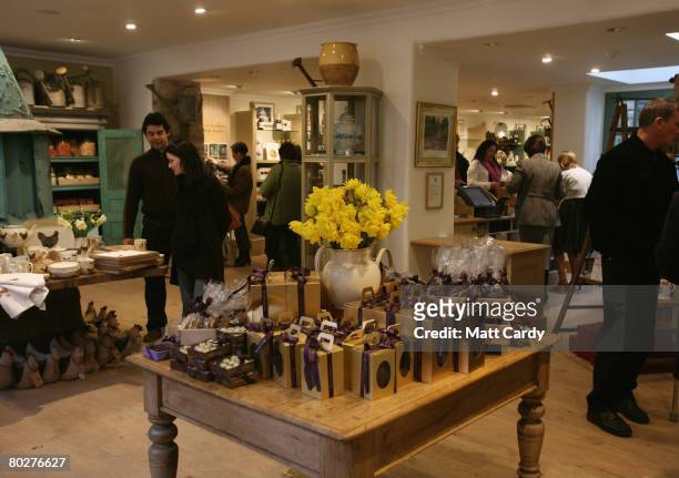 Customers browse products displayed in the Highgrove shop opened by Prince Charles, Prince of Wales and Camilla, Duchess of Cornwall on Tetbury High...