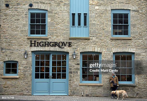 Woman waits with her dog outside the Highgrove shop opened by Prince Charles, Prince of Wales and Camilla, Duchess of Cornwall on Tetbury High Street...