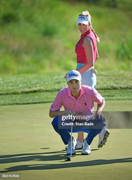 Paige Spiranac and Justin Thomas play the seventh hole during the Pro-Am round for the Quicken Loans National at TPC Potomac at Avenel Farm on June...