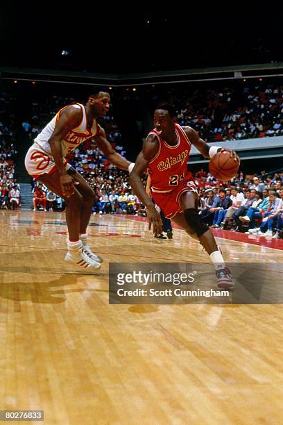 Michael Jordan of the Chicago Bulls dribbles against the Atlanta Hawks during his rookie season of 1984 at the Omni in Atlanta, Georgia. NOTE TO...