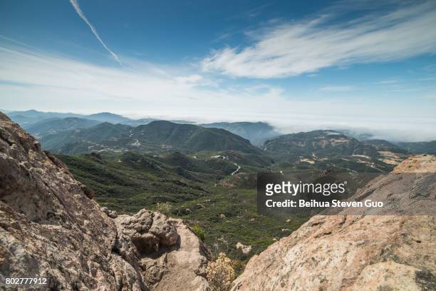 view of foggy malibu and the pacific ocean from the summit of sandstone peak, santa monica mountains national recreation area, california - piuma stock pictures, royalty-free photos & images