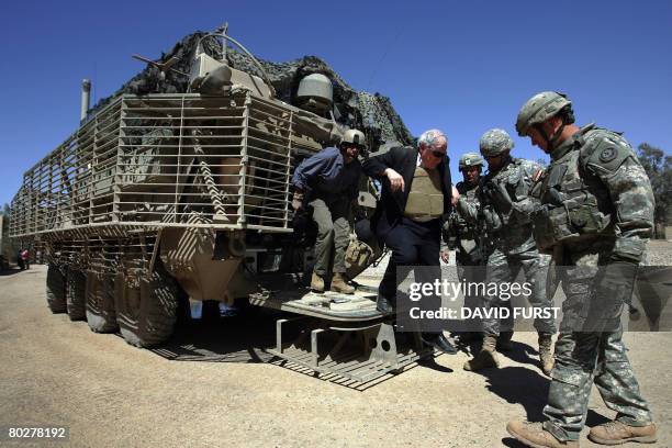 Democratic senator and chairman of the US Armed Services Committee, Carl Levin, steps out of an armoured Stryker fighting vehicle as he arrives at a...