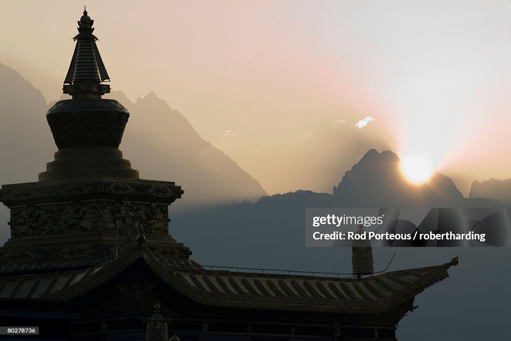 Buddhist temple at dawn with mountains beyond, Snow mountain, Tagong Grasslands, Sichuan, China, Asia