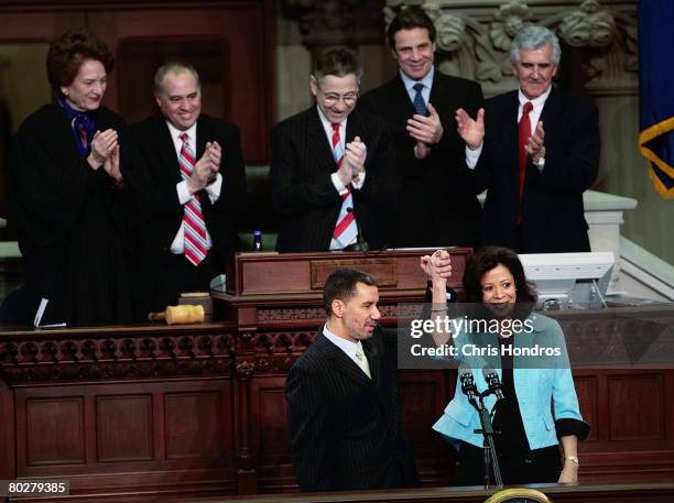 New York Governor David Paterson David Paterson holds up the hand of his wife Michelle Paige Paterson after being sworn in after being sworn in as...