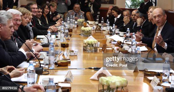 German Chancellor Angela Merkel and Israeli Prime Minister Ehud Olmert oversee a meeting between several of their countries' ministers at the Israeli...