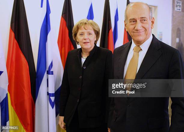 German Chancellor Angela Merkel and Israeli Prime Minister Ehud Olmert arrive for a meeting between several of their countries' ministers at the...
