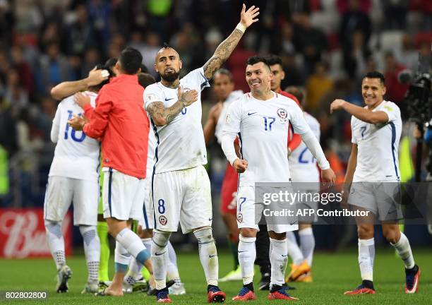 Chile's midfielder Arturo Vidal gestures as defender Gary Medel looks on as they celebrate after Chile won the 2017 Confederations Cup semi-final...