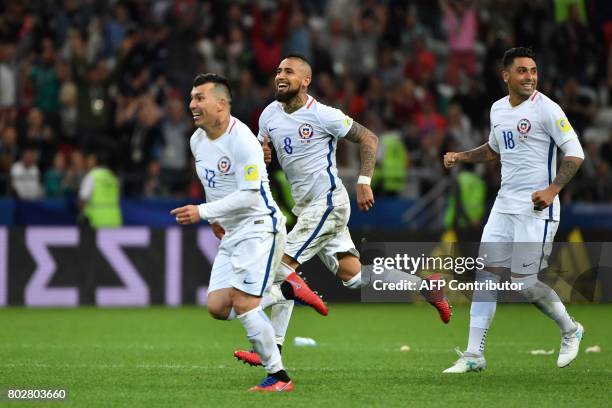 Chile's defender Gary Medel, Chile's midfielder Arturo Vidal, and Chile's defender Gonzalo Jara celebrate after Chile won the 2017 Confederations Cup...