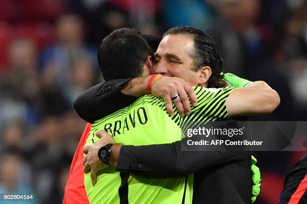 Chile's goalkeeper Claudio Bravo and Chile's Spanish coach Juan Antonio Pizzi celebrate after Chile won the 2017 Confederations Cup semi-final...