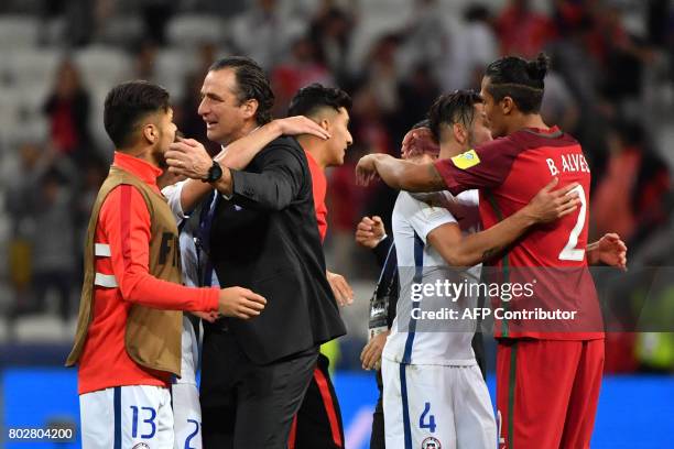 Chile's Spanish coach Juan Antonio Pizzi congratulates players after Chile won the 2017 Confederations Cup semi-final football match between Portugal...