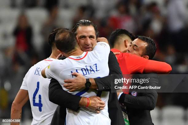 Chile's Spanish coach Juan Antonio Pizzi celebrates with players after Chile won the 2017 Confederations Cup semi-final football match between...