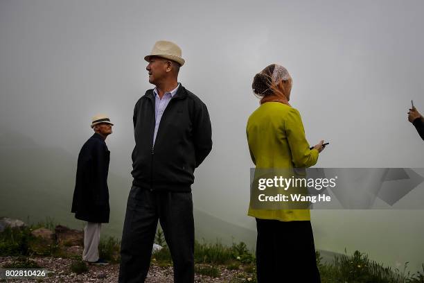 Hui nationals stand on the roadside of the Duku highway on June 28.017 in Xinjiang Uygur Autonomous Region, China. The Duku highway from Dushanzi to...