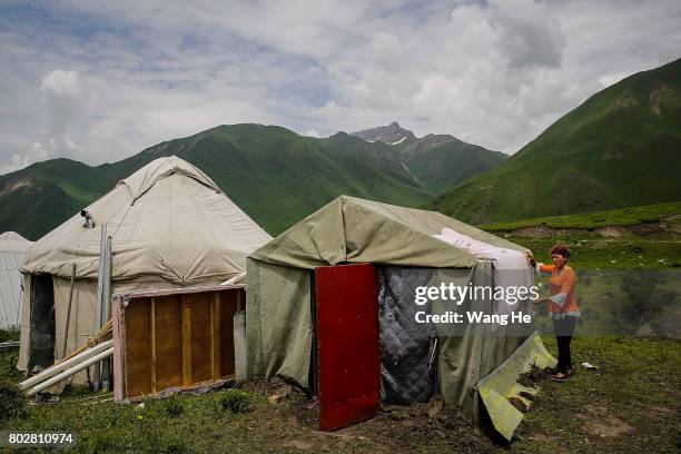 Hui national dries quilts on a tent near the Duku highway on June 28.017 in Xinjiang Uygur Autonomous Region, China. The Duku highway from Dushanzi...