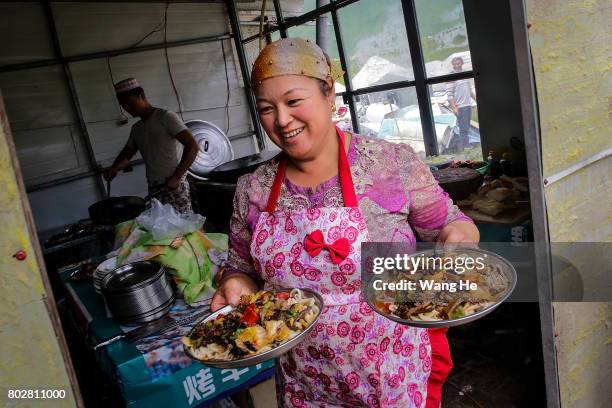 Hui national serves dishes in a restaurant near the Duku highway on June 28.017 in Xinjiang Uygur Autonomous Region, China. The Duku highway from...