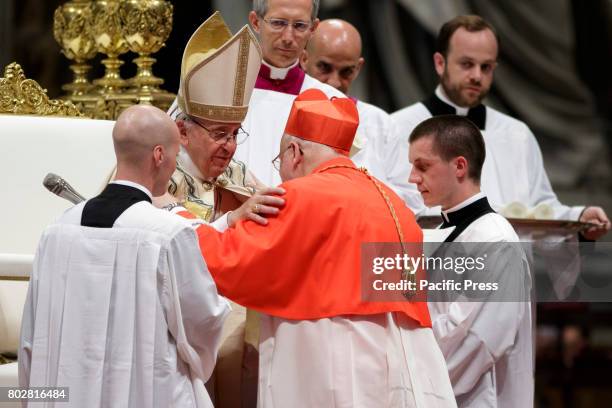 New Cardinal Anders Arborelius, Archbishop of Stockholm, receives the red three-cornered biretta hat from Pope Francis during the Ordinary Public...