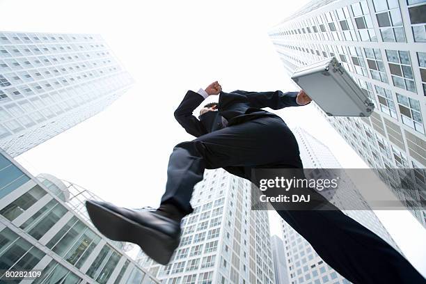 businessman jumping, china, beijing - running dynamic worms eye view stock pictures, royalty-free photos & images