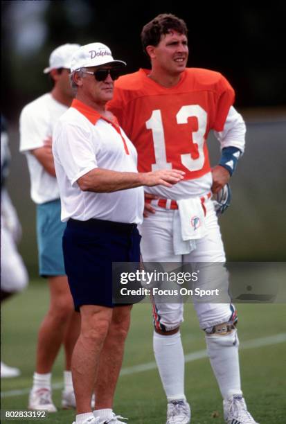 Quarterback Dan Marino of the Miami Dolphins looks on with head coach Don Shula during a practice circa 1991 in Miami, Florida. Marino played for the...