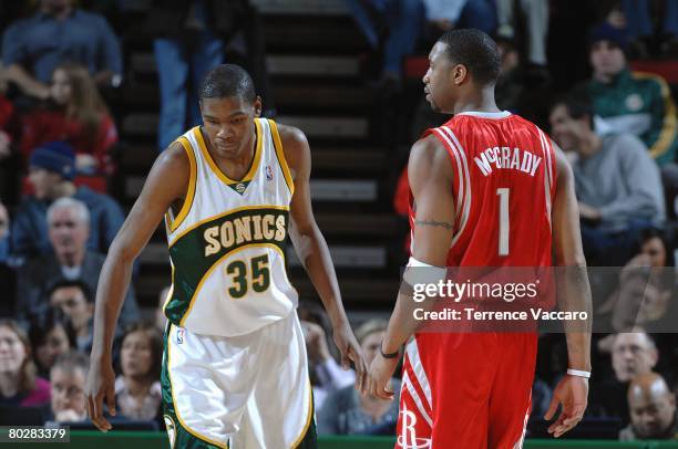 Kevin Durant of the Seattle SuperSonics defends against Tracy McGrady of the Houston Rockets during the game on January 23, 2008 at the Key Arena in...