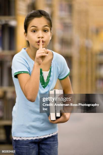 mixed race girl shushing in library - child gesturing stock pictures, royalty-free photos & images