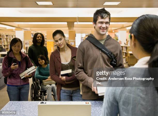 multi-ethnic people checking out library books - native korean stock pictures, royalty-free photos & images