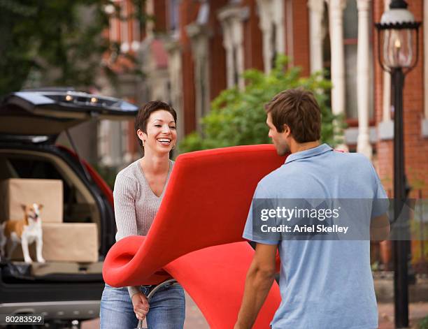 hispanic couple carrying furniture - young couple shopping stock pictures, royalty-free photos & images