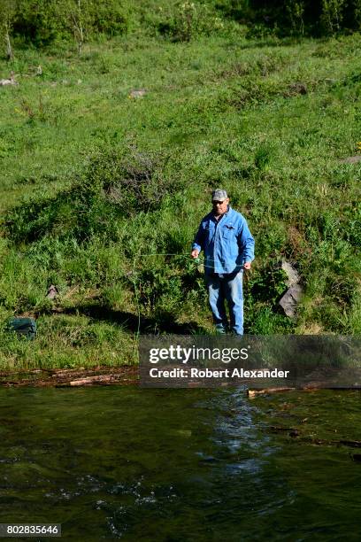 Fisherman casts his line in Maroon Creek in the Maroon Bells-Snowmass Wilderness of White River National Forest near Aspen, Colorado.